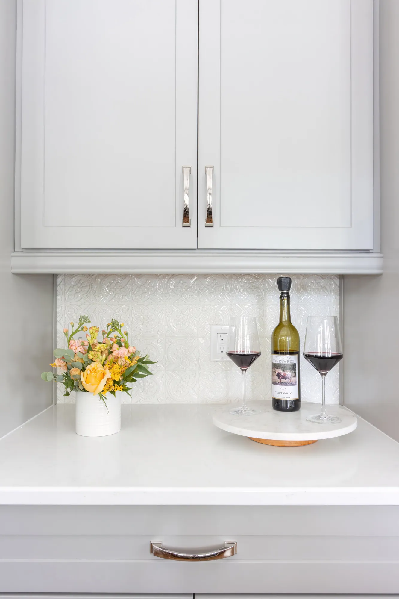 Kitchen bar cabinetry with wine glasses