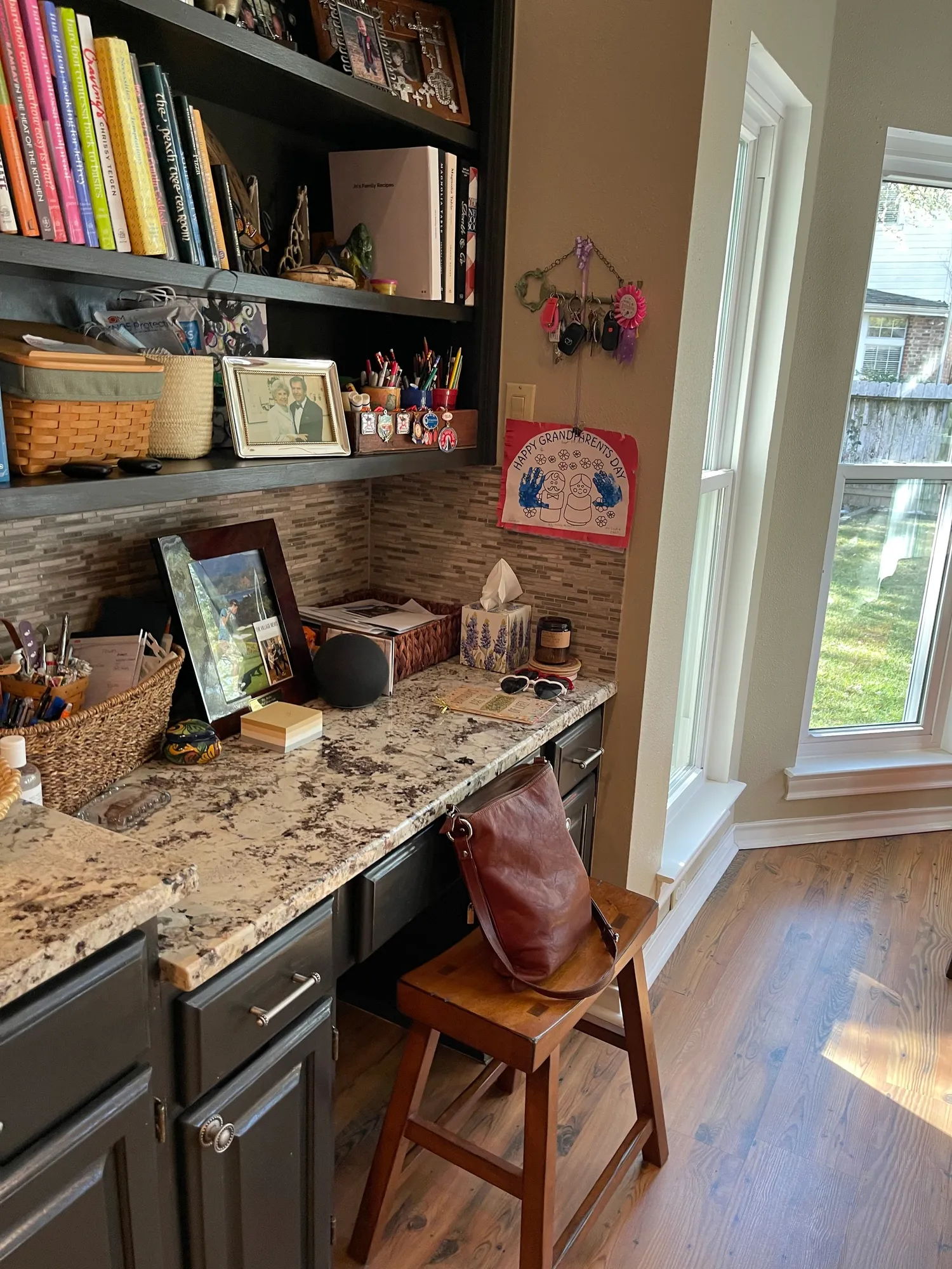 Before: built-in desk with dark open shelving and granite counter
