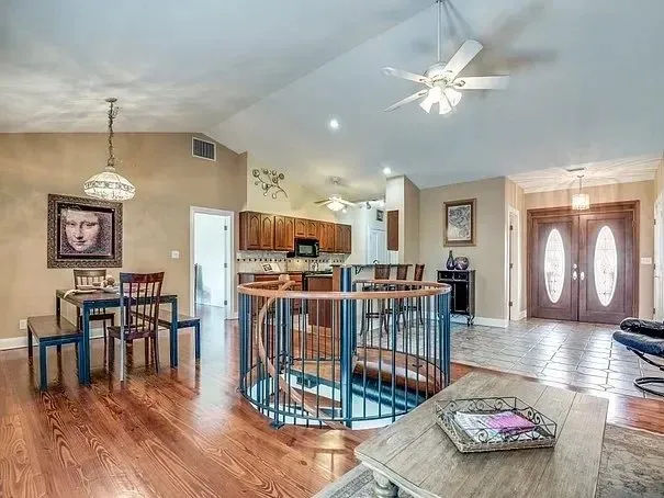 Kitchen with dark wood cabinets opening onto a dining area