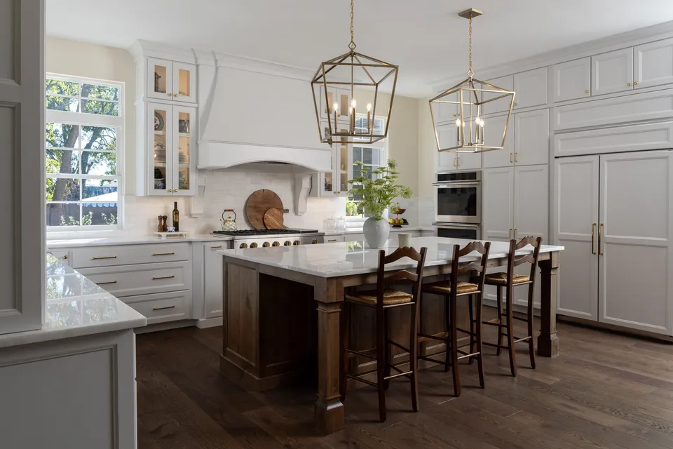 Roosevelt Cottage Wing kitchen with a dark island and lantern pendants