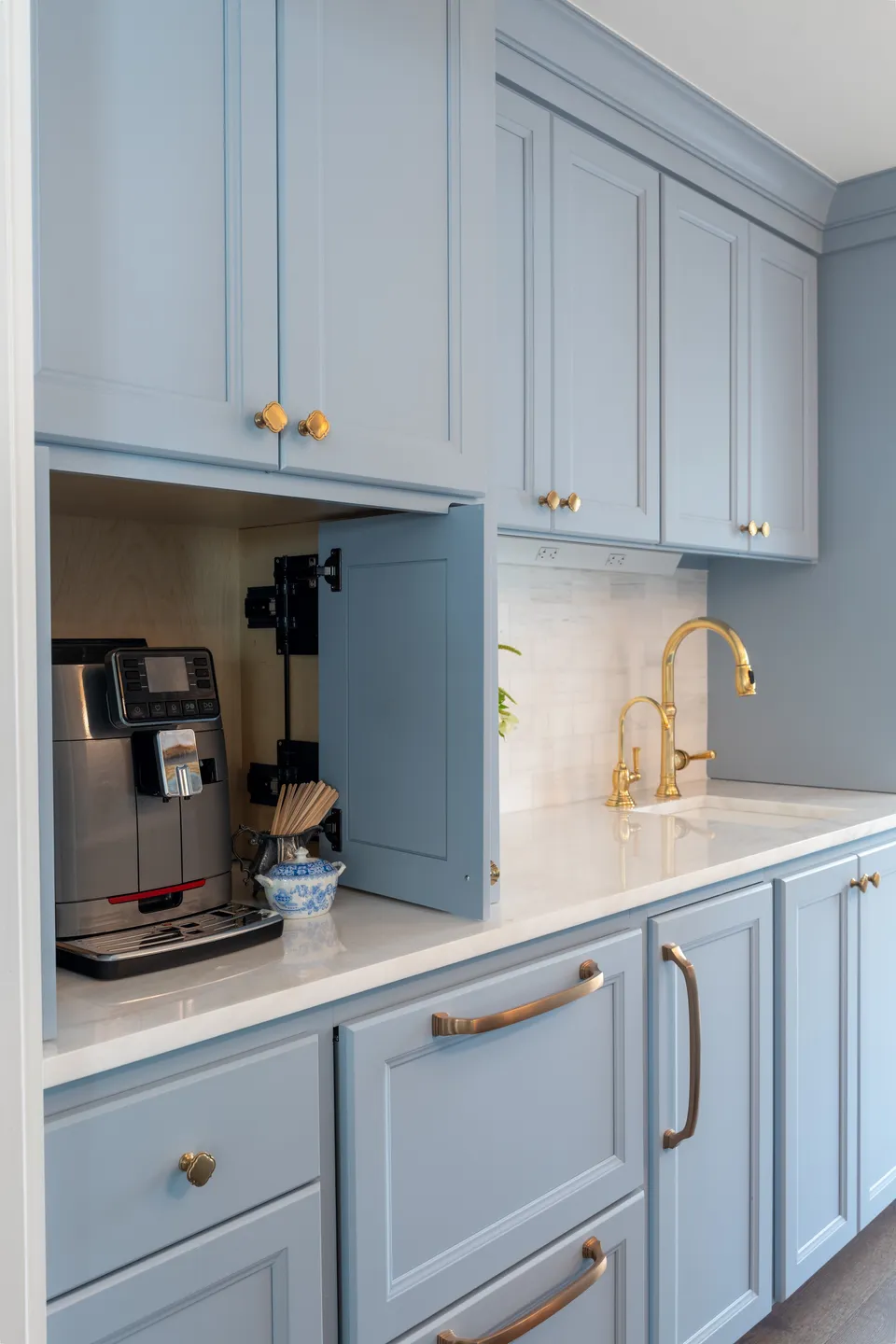 Butler pantry with pale blue cabinets and a built-in coffee station